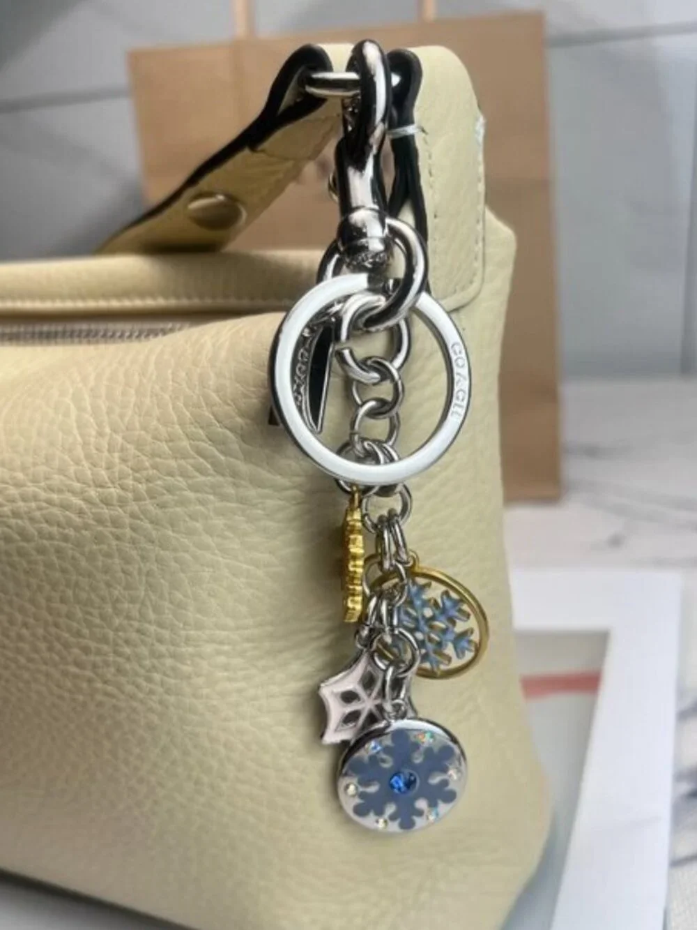 Coach Silver-Tone & Light Blue Snowflake Charm Keychain with Gold Accent